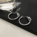Detail of silver knot hoop earrings showing smooth metallic luster and minimalist design - Knot Smooth Hoop Earrings / Silver