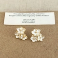 Three-cluster white floral stud earrings with gold metal base on display card - White Enamel Flower Studs (A-415)