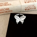 Detailed macro view of 3D butterfly open ring with matte finish and delicate textures - Silver