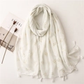 White linen scarf with golden swallow prints and tassels on a minimalist table setting - White