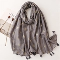 Detail of gray cotton linen scarf with golden swallow pattern and fringe edges - Gray