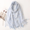 Detail of light blue linen scarf with gold swallow prints and elegant fringe tassels - Blue