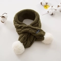 Detailed knit texture of green children's scarf with white pompoms and handmade label - Army Green
