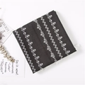 Detail of black cotton linen scarf featuring white star patterns and fringe edges - Black
