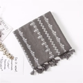 Detailed embroidery of white cross stars on dark gray linen scarf with handmade tassels - Heather Grey