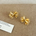 Elegant gold bow earrings with sparkling white crystals displayed on a textured card - Golden Full Rhinestone Bow (A-683)