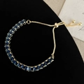 Close-up of adjustable gold bracelet with square-cut dark blue zircon stones - Dark Blue
