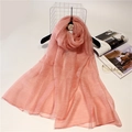 Close-up of coral pink silk wool scarf with subtle texture on a minimalist hanger - 190cm x 90cm / Pink