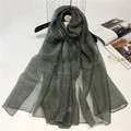 Detail shot of sheer grey silk wool scarf featuring fine horizontal texture on hanger - 190cm x 90cm / Dark Green
