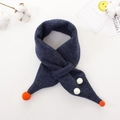 Flat lay of navy blue knitted baby scarf with orange pompoms and cute ball details - Navy Blue