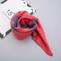 Macro detail of thick floral knit scarf showing soft texture and folded warm material - Red (Grey-Red Flower Print)