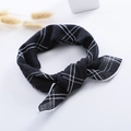 Detail view of the black and white gingham linen scarf with a decorative bow knot - Large Black Plaid