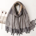 Close-up of elegant floral print scarf with gray fringe tassels and lifestyle props - 180x90cm / Grey (SL2212-008)