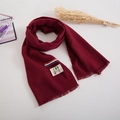 Detail of soft burgundy knit scarf with cute bear patch, tricolor ribbon and short tassels - Burgundy