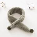 Detailed texture of grey-green plush toddler scarf with soft faux fur and pom-poms - Fruit Green