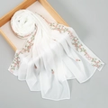 Detail of white chiffon scarf with pink floral embroidery and lace edges on wooden tray - 170x70cm / White