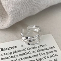 Macro detail of silver triple-layered twisted geometric ring with polished finish - Silver