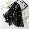 Detail of soft black voile scarf with white polka dots draped on a plush white texture - 1# Black