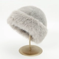 Close-up of light gray faux fur Mongolian hat texture on a golden metal display stand - 31*20 / Grey Marble