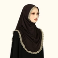 Detail of dark brown chiffon hijab with intricate gold floral lace edge on soft knit fabric - Coffee