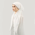Detail of white cotton linen hijab featuring champagne rhinestones and soft draped texture - White