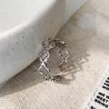 Macro view of adjustable silver hollow floral ring featuring clover cut-out details - Silver Hollow Flower Ring