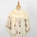 Detailed view of cream knitted scarf featuring decorative pom-pom on mannequin torso - 86*36cm / Beige