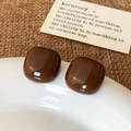 Macro view of square coffee enamel studs on a ceramic dish with rustic linen - Coffee