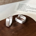 Close-up of square brushed silver earrings with matte texture and minimalist geometric design - Silver