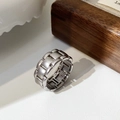 Detailed view of matte silver link chain ring on textured background with soft lighting - Chain Ring / Silver