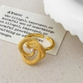 Detail of a vintage gold beaded spiral ring featuring a single white pearl accent - Gold
