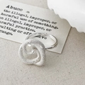 Close-up of matte silver snake-shaped ring with a central white pearl and spiral design - Silver