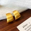 Detail of gold brushed matte metal texture on minimalist C-shaped geometric earrings - Gold Color Brushed Stud Earring