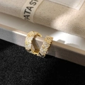 Macro shot of gold V-shaped ear cuff featuring sparkling cubic zirconia stones - Gold White Zirconia Ear Cuff