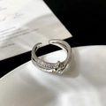 Detailed view of silver crossover ring featuring micro-pave white zircon crystals - Cross Intertwined Micro Pave Ring / Silver