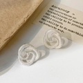 Primer plano de pendientes de plata con textura de serpiente y una perla blanca - Plateado