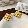 Detail view of square gold earrings featuring a luxury quilted textured finish - Gold