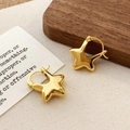 Detail showing polished gold star earrings on minimalist background with warm lighting - Star Hoop / Gold