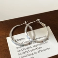 Detailed view of silver geometric hoop earrings with smooth and textured metal finish - Silver
