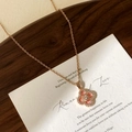 Macro detail of rose gold clover pendant with pink inlay and sparkling micro zircons - Rose Gold Pink Four Leaf Clover Necklace