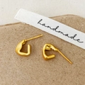 Detail of matte gold irregular C-shaped earrings on brown paper with handmade ribbon - Gold Earrings