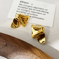 Macro shot of gold pleated earrings with polished mirror finish on a minimalist background - Wrinkled Studs / Gold