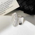 Macro shot of asymmetrical silver ring with hollow mesh grid and smooth metal finish - Adjustable Open Design / Silver