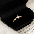 Macro view of a gold-plated ring with a square zircon in a black velvet jewelry box - Gold Ring