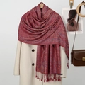 Elegant burgundy paisley shawl with tassels styled over a coat for autumn winter fashion - Wine Red