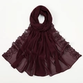 Detail view of burgundy chiffon scarf featuring delicate rose embroidery and elegant hem. - Burgundy