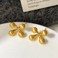 Detail of matte gold star stud earrings with brushed metal finish on white ceramic - Gold Color Brushed Stud Earring