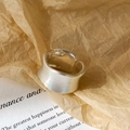 Close-up of wide brushed silver adjustable ring with a matte finish and wavy edges - Brushed Silver / Silver