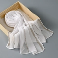 Detail of white chiffon hijab scarf with elegant gold and silver beaded stripe pattern - White