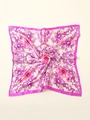 Detailed close-up of pink floral silk scarf with baroque patterns and purple border - Pink